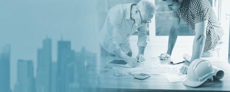 Architects working on plans at office; multiple exposure