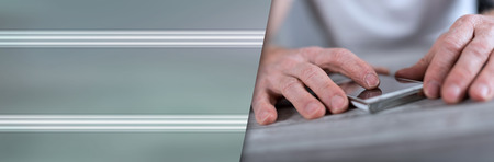 Finger touching a smartphone screen. panoramic banner