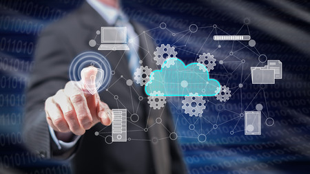 Man touching a cloud computing concept on a touch screen with his fingers