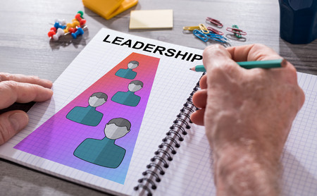Hand drawing leadership concept on a notepad