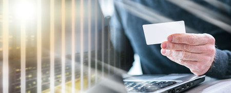Man using his credit card for online payment; multiple exposureの写真素材
