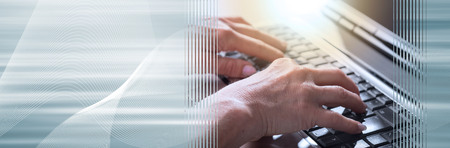 Female hands typing on a laptop keyboard, light effect. panoramic banner