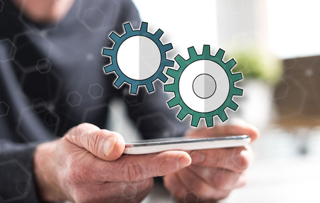 Hands of man holding a smartphone with setting concept