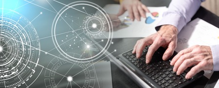 Hands of businessman using laptop at office; multiple exposure