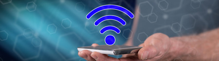 Wifi concept above a smartphone held by a manの写真素材