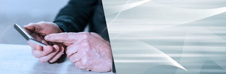 Male hands using his mobile phone. panoramic bannerの写真素材