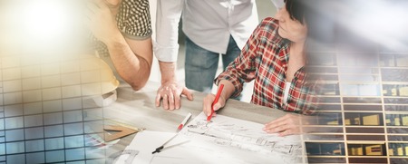 Architects working on plans at office; multiple exposure