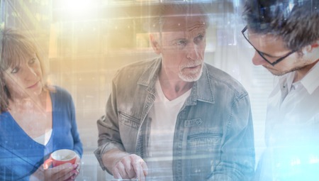 Coworkers having a business discussion in office, light effect; multiple exposureの写真素材