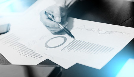 Businessman analyzing graphics at officeの写真素材