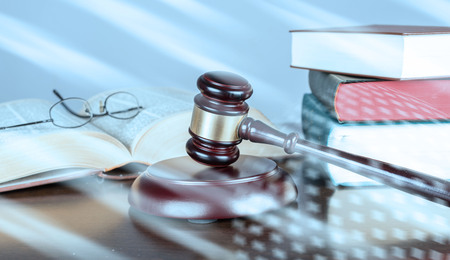 Judge gavel with law books; light effect
