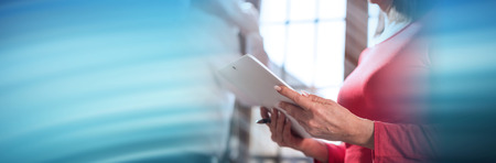 Businesswoman working on tablet in office; panoramic bannerの写真素材