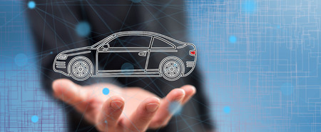 Car transport concept above the hand of a man in backgroundの写真素材