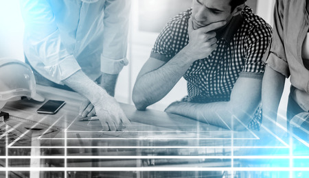Architects working on plans at office, light effect; multiple exposure
