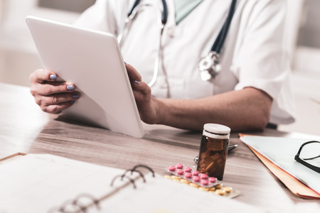 Femaler doctor using digital tablet in medical officeの写真素材