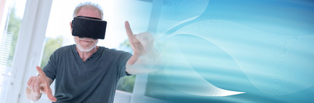 Senior man using a virtual reality headset; panoramic banner