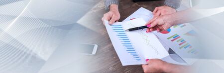 Team discussing about financial charts; panoramic banner