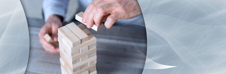 Business development concept by building a tower with domino blocks. panoramic banner