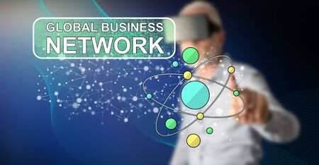 Man with vr headset touching a global business network concept on a touch screen with his fingerの写真素材