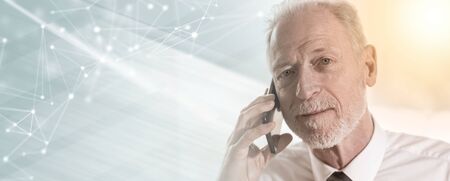 Portrait of senior businessman talking on mobile phone; multiple exposure