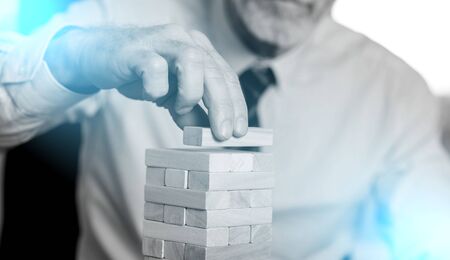 Business development concept by building a tower with domino blocksの写真素材