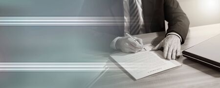 Businessman signing a document in office (lorem ipsum text used)