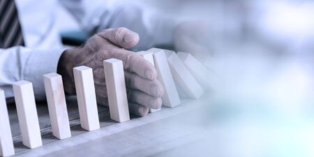 Business control concept by stopping domino effect, light effect