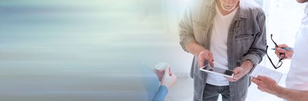 Coworkers having a business discussion in office, light effect. panoramic banner