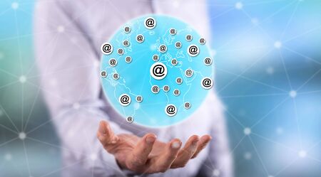 Global communication concept above the hand of a man in backgroundの写真素材