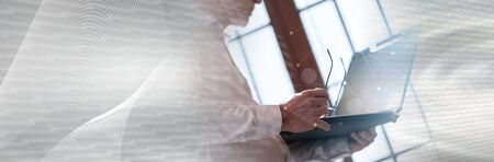 Senior businessman using laptop, light effect, double exposure with network; panoramic bannerの写真素材