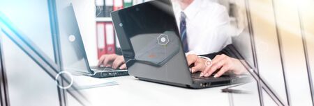 Businesspeople working on a laptop during training. multiple exposure