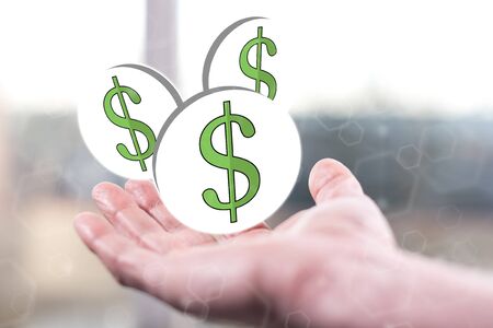 Dollar concept above a hand of a manの写真素材