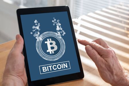 Tablet screen displaying a bitcoin conceptの写真素材