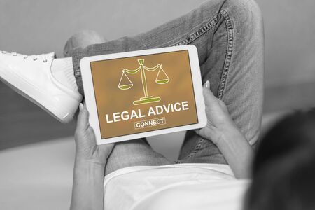 Woman looking at legal advice concept on a tabletの写真素材