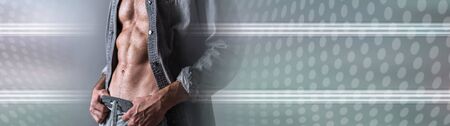 Muscular young man in grey shirt; panoramic bannerの写真素材