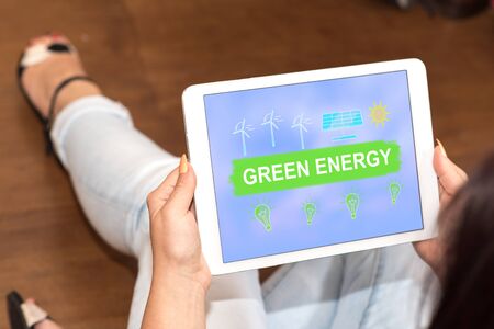 Tablet screen displaying a green energy conceptの写真素材