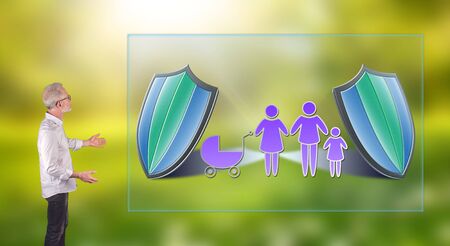 Businessman showing a family insurance concept on a wall screen