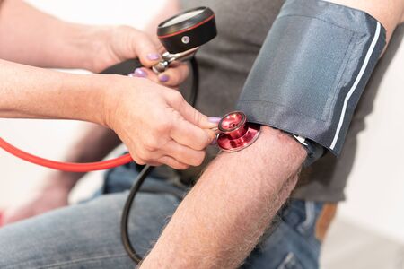 Mesure of blood pressure with sphygmomanometerの写真素材