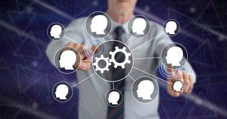 Man touching a teamwork concept on a touch screen with his fingers