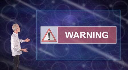 Businessman showing a warning concept on a wall screenの写真素材