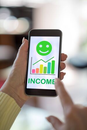 Smartphone screen displaying an income growth conceptの写真素材