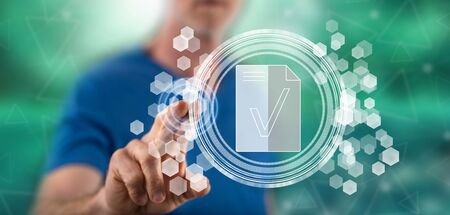 Man touching a document validation concept on a touch screen with his fingerの写真素材