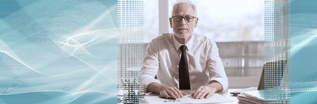 Portrait of mature businessman sitting in office. panoramic bannerの写真素材
