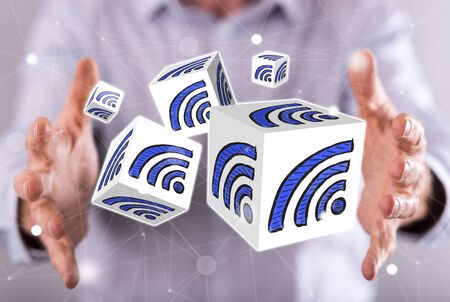 Wifi concept between hands of a man in backgroundの写真素材