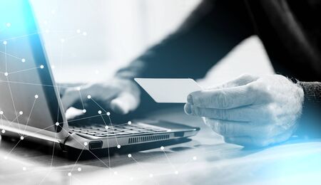 Man using his credit card for online payment; light effect