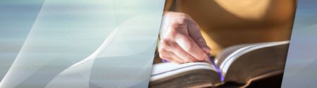 Close up of woman reading the bible, hard light; panoramic bannerの写真素材