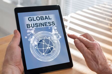 Tablet screen displaying a global business conceptの写真素材