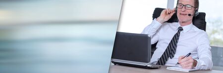 Support phone male operator in headset; panoramic bannerの写真素材