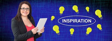 Woman using digital tablet with inspiration concept on backgroundの写真素材