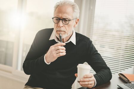 Portrait of thoughtful senior businessman at office