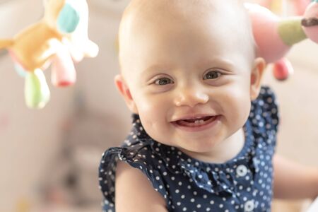 Portrait of smiling little cute baby girlの写真素材